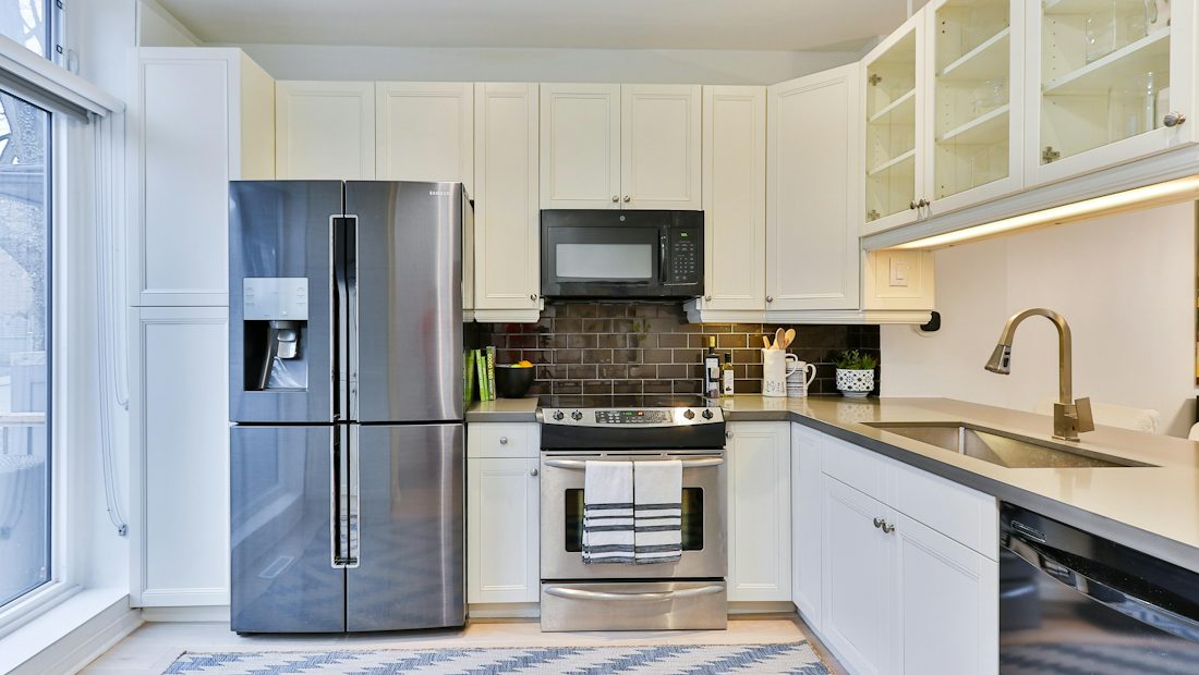 Stainless steel fridge freezer in a white kitchen