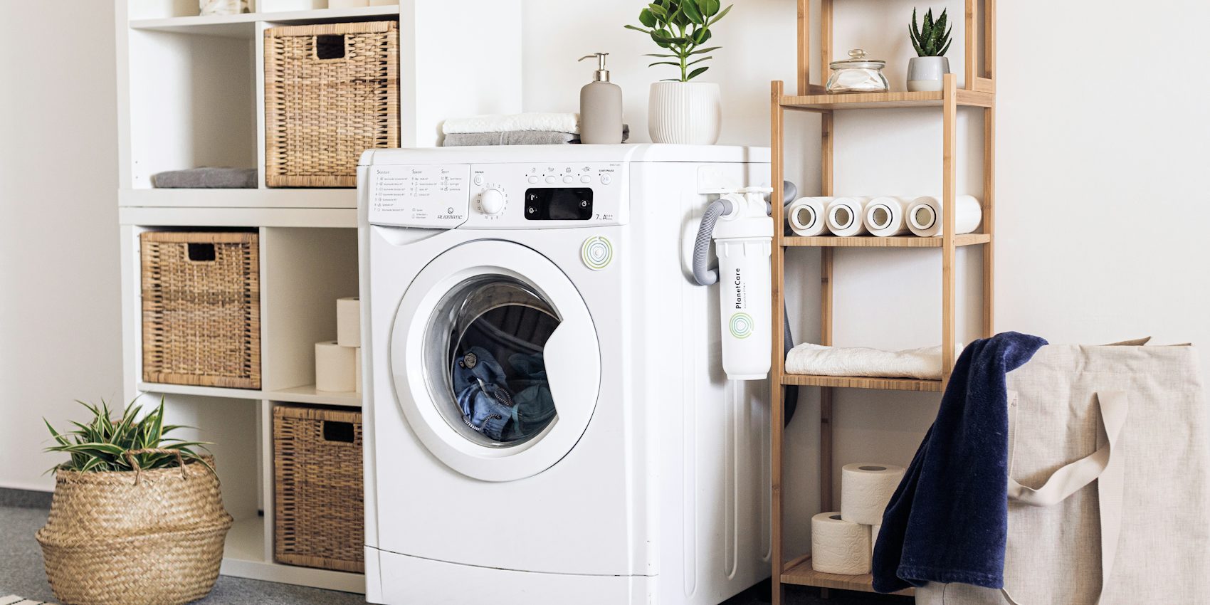 White front-loading washing machine in a tidy utility room