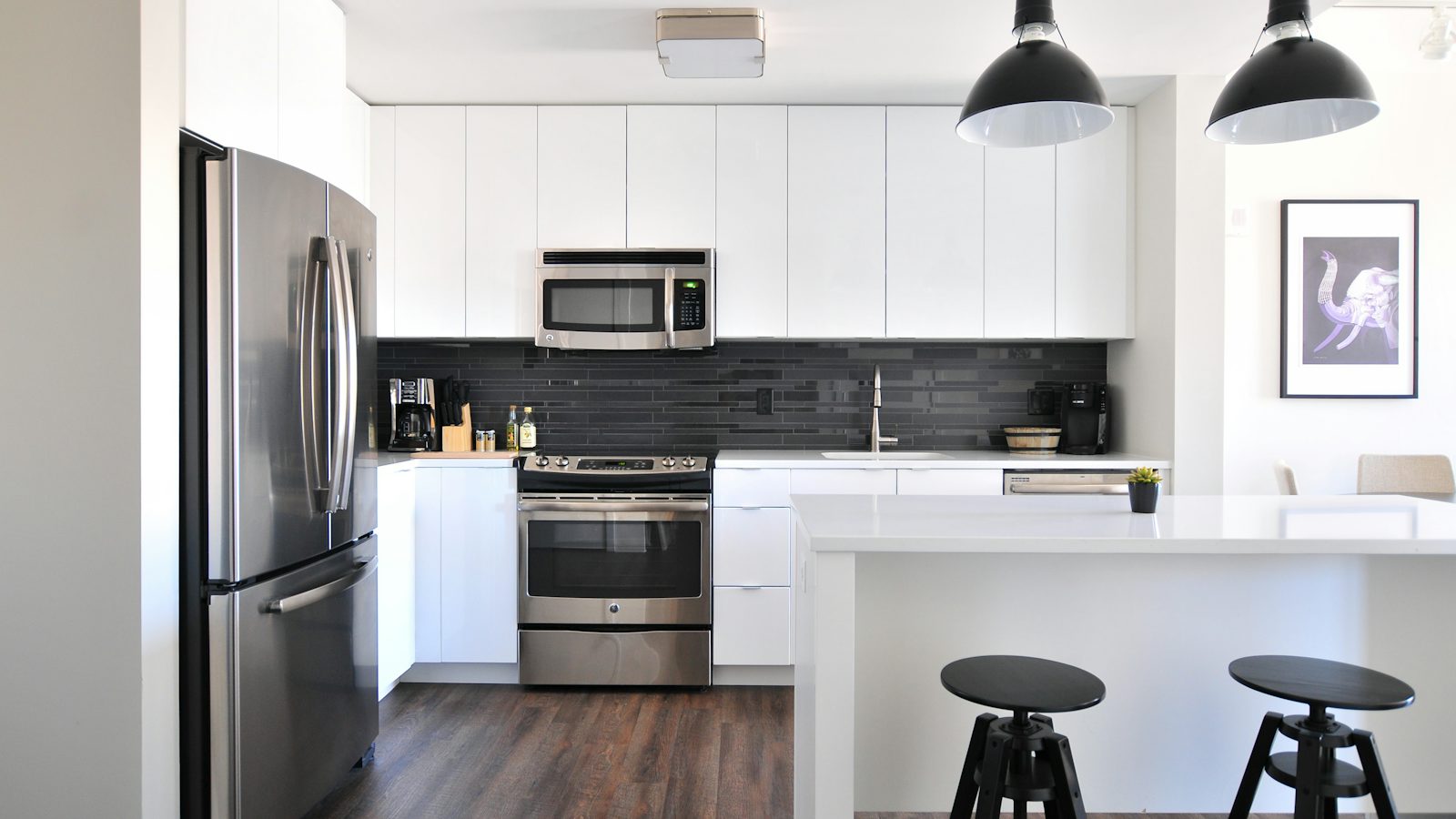 Modern fitted kitchen with stainless steel appliances